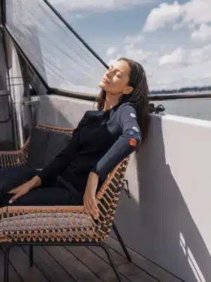 Photo porté décadré du pull femme grande taille ROZEN Marine assis dans un fauteuil en osier